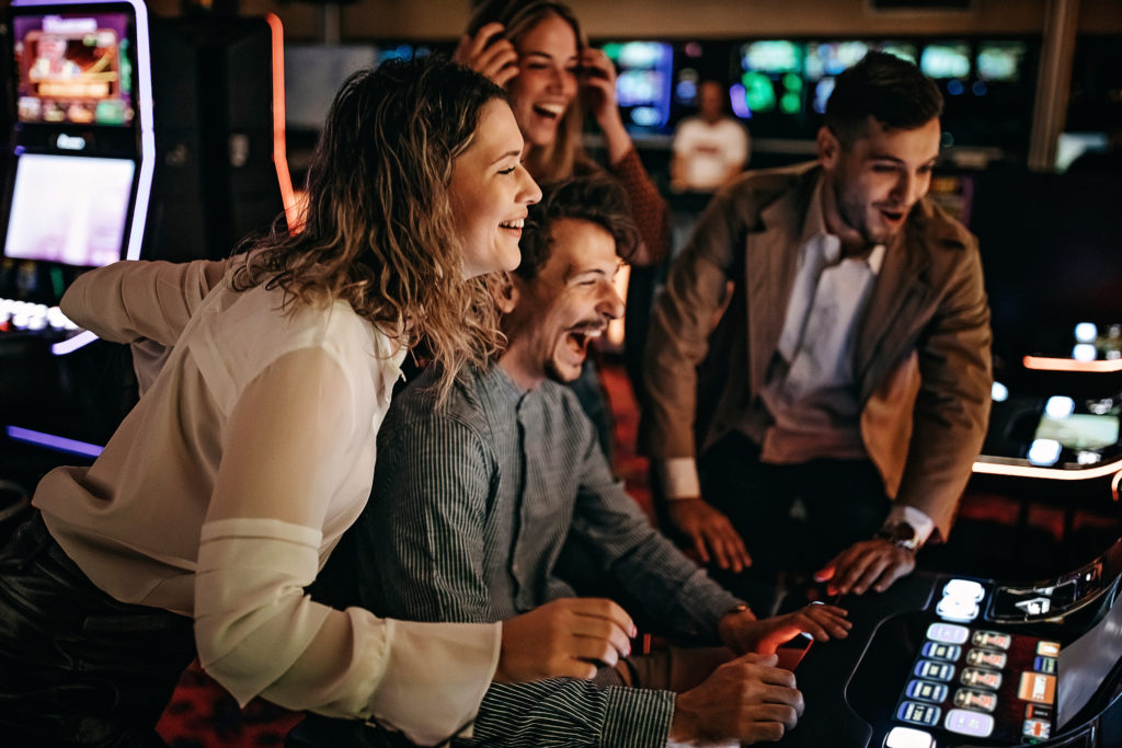 young people gambling at a slot machine