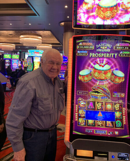 Man having just won slots jackpot at Legends Bay Casino